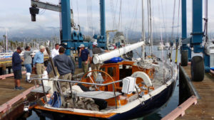 Sailboat being lowered in the harbor at Santa Barbara using Marine Travelift