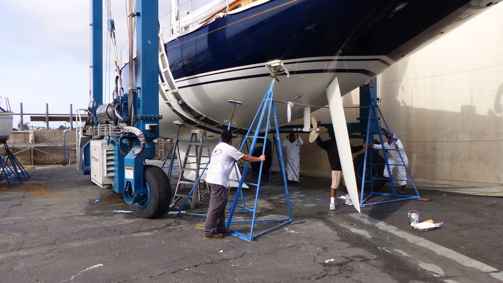 Blocks being removed from sailboat being lifted by Marine Travelift